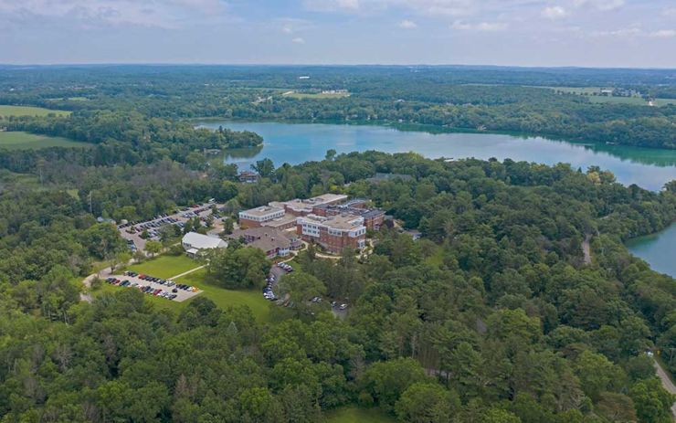 aerial view of Rogers location by lake with trees