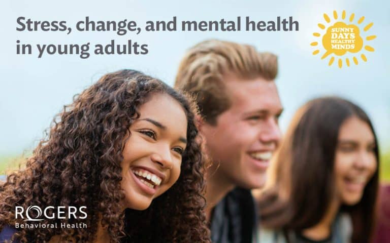 The image features three young adults, all smiling and facing towards the right side. The foreground focuses on a woman with curly hair, joyously smiling. Next to her is a man with short hair, also smiling widely. In the background, another young woman is smiling. The background is blurred, suggesting an outdoor setting. At the top left, the text reads, "Stress, change, and mental health in young adults." In the top right corner, a sun icon contains the text "Sunny Days Healthy Minds.