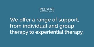 Blue ground with white text about inpatient mental health care that says, "We offer a wide range of support from individual and group therapy to experiential therapy."
