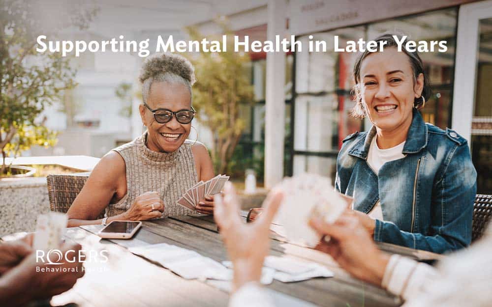 The images features several older women playing cards outside to benefit their mental health. Text says: Supporting Mental Health in Later Years