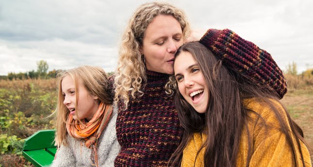 A mother with teenage and tween daughters