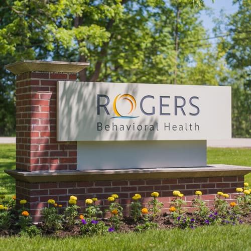 Brick monument sign featuring the Rogers Behavioral Health logo.