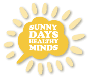 A sunburst design with a central yellow brain shape containing text that reads "Sunny Days, Healthy Minds", surrounded by light yellow rays.